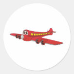 Desenhos animados vermelhos do avião de passagem adesivos em formato redondos