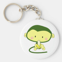 Macaco bonito dos desenhos animados que come uma b chaveiros