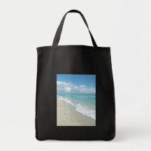 Pegadas no Sandy Beach branco, azul cénico do Aqua Bolsa Para Compra