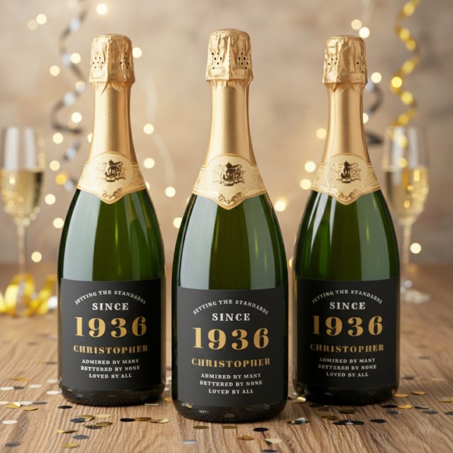 90th Birthday Born 1936 Add Name Black Gold (Born 1936 sparkling wine bottle labels. Background out of focus.)