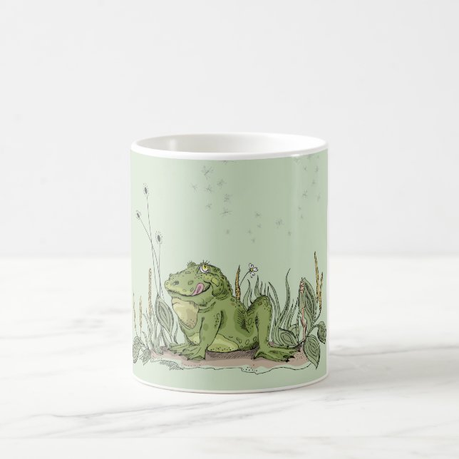 A caneca com imagem engraçada do sapo verde (Centro)