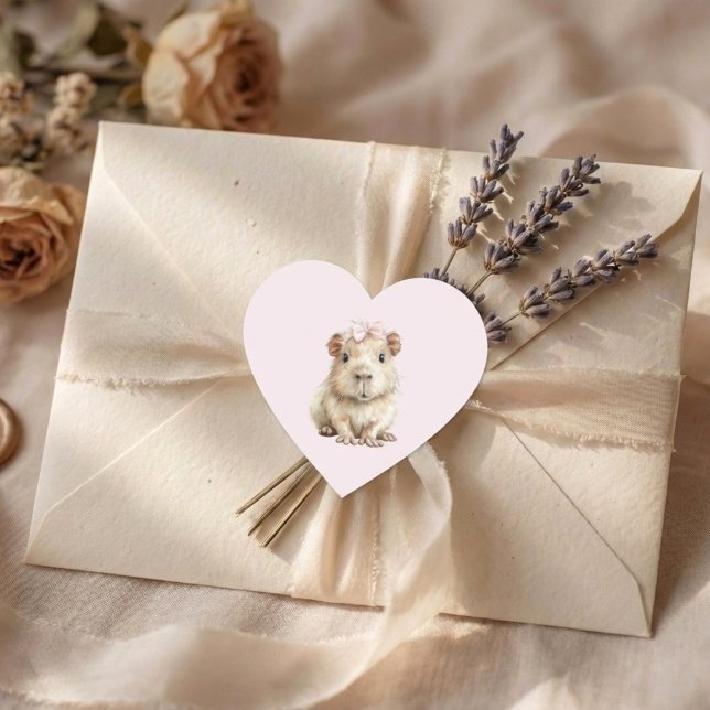 Adesivo Coração Capybara Birthday (heart sticker with cute capybara on cream envelope with lavender and soft fabric background)