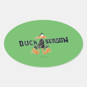 Adesivo Oval DAFFY DUCK™ "Duck Season" desintegrado