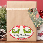 Adesivo Oval Jolly Christmas Elf Legs Stripes Holiday OVAL<br><div class="desc">Pernas de elfo divertidas vestindo pontas listradas vermelhas e marfim e botas verdes com sinos de jingle, e seus detalhes natalinos de Natal em cartazes chic, esses adesivos OVAL são bonitos para favoritos para festas, presentes, envelopes de convite, presentes de comida caseira e muito mais. ***TODAS AS FORMAS já foram...</div>