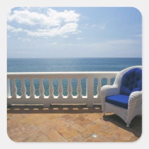 Adesivo Quadrado Porto Rico. Cadeira de vime e terraço ladrilhado n