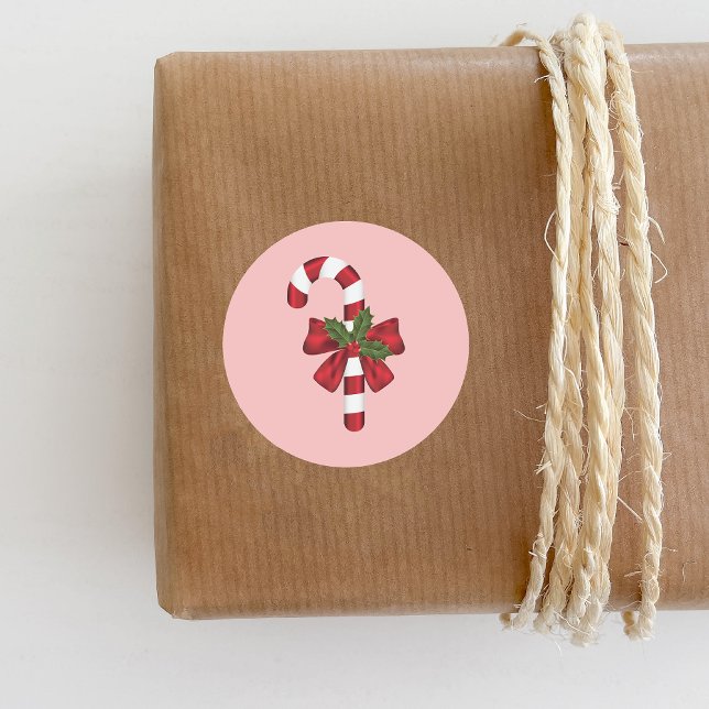 Adesivo Redondo Canela De Doces Com Arco E Holly De Natal A Rosa (Festive candy cane design for the Holiday season.)