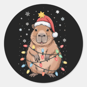 Adesivo Redondo Capivara de Natal com Chapéu de Papai Noel Luzes d