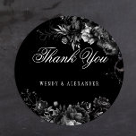 Adesivo Redondo Casamento Gótico Clássico Negro Obrigado<br><div class="desc">Apresentando a atração do eterno do nosso Casamento Gótico Clássico Negro Obrigado design do Adesivo Redondo Clássico, onde a elegância encontra o etéreo. Um toque encantador de romance escuro adorava-se com intrincados motivos botânicos, com fundo preto embelezado com peonias luxuosas e rosas delicados que exaltam uma sofisticação temperamental perfeita para...</div>