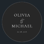 Adesivo Redondo Chic Script Black Minimalist Wedding<br><div class="desc">Add a personal and elegant touch to your wedding favors, envelopes, or packaging with this minimalist round sticker featuring your custom name in a graceful script font. Designed to complement a modern and timeless wedding theme, this classic black-and-white design pairs beautifully with any part of your celebration. Perfect for sealing...</div>