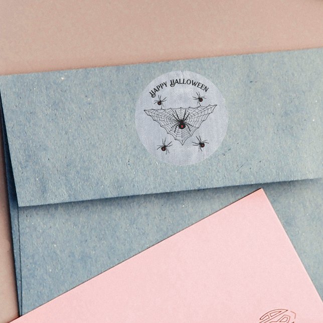 Adesivo Redondo Creepy Crawling Black Widow Spiders Web White (Black widow spiders in black web with red hourglass marks on rustic white Halloween stickers.)