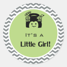 É uma menina verde, cinza com adesivos.