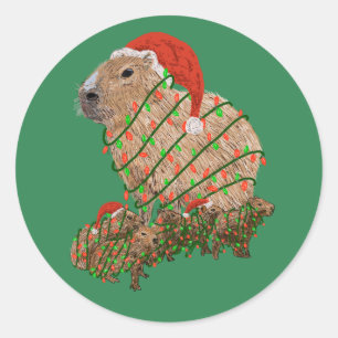Adesivo Redondo Família Capybara de Natal Envolvida em Luzes