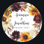 Adesivo Redondo Favor de Agradecimento de Casamento Floral Outonal<br><div class="desc">As flores dramáticas do outono incluem girassóis amarelos, peônias roxas, rosas vermelhas escuras e hortênsias brancas marfim. Elas estão aninhadas em folhas de outono e videiras para criar uma grinalda muito bonita. Os nomes do casal estão escritos em uma fonte grande de caligrafia. O sentimento de agradecimento segue. Esta adesivo...</div>