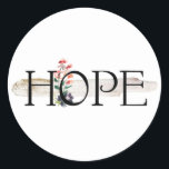 Adesivo Redondo Hope Sticker<br><div class="desc">Um belo gráfico sobre uma enxurrada de arenoso stucco e uma pequena decoração de flor d'água melhora a mensagem de positividade HOPE, fácil de preparar e fácil na mente. Vai com todas as oportunidades chamando por um adesivo.</div>