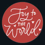 Adesivo Redondo Joy To The World Lettering Red Christmas<br><div class="desc">Alegria ao mundo,  o Senhor vem! Adicione um sotaque festivo aos seus envelopes,  cartões e presentes com este adesivo de férias. Apresenta caligrafia moderna com fundo vermelho. Este adesivo de Natal é perfeito como um selo de envelope e para embalagem de presente.</div>
