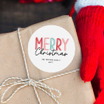 Adesivo Redondo Modern Bold Colorful Felry Christmas Family Name<br><div class="desc">O design de etiqueta de Natal contém uma inscrição colorida e ousada que diz "Feliz Natal" numa mistura de tons vermelhos, cor-de-rosa e verdes, acrescentando uma vibração alegre e festiva. A palavra "Feliz" está em letras maiúsculas, com uma combinação divertida de cores, enquanto "Natal" é escrito em um roteiro casual...</div>