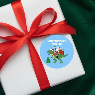 Adesivo Redondo Papai Noel Engraçado Montado no T-Rex no Natal