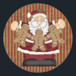 Adesivo Redondo Papais noeis<br><div class="desc">Este presente de Natal apresenta um Papai Noel bonitinho segurando uma terra comestível de biscoitos de Natal para homens de gengibre.</div>