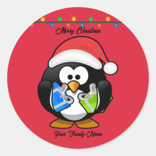 Adesivo Redondo Pinguim de fundo vermelho segurando presentes de N