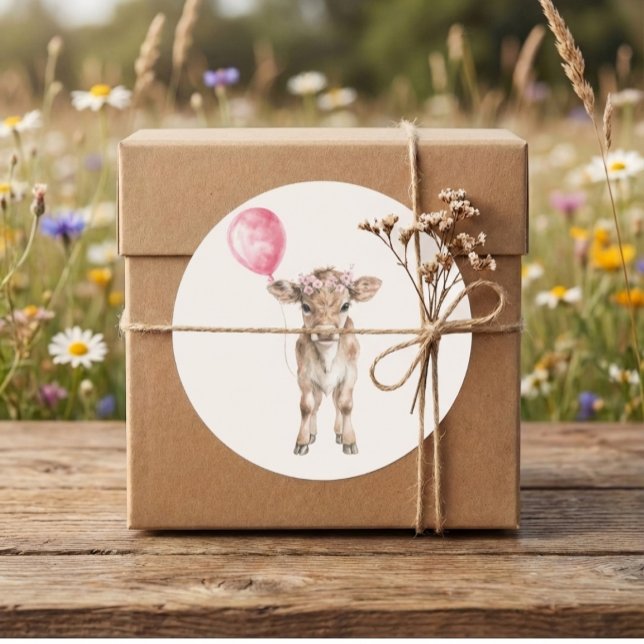 Adesivo Redondo Pink Cowgirl Birthday | Farm Theme 1st  (cowgirl calf sticker on kraft gift box with twine on rustic table in a wildflower meadow)