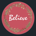 Adesivo Redondo Winter Greenery Berries Wreath Christmas Acredita<br><div class="desc">Vedante de envelope festivo elegante e moderno ou adesivo de presente para o Natal com o texto "Acredite" na caligrafia branca em um fundo vermelho e um toque de na moda do verde de inverno e da coroa de frutas. Desenvolvido exclusivamente para você pelo Happy Dolphin Studio. Se precisar de...</div>