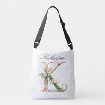 Bolsa transversal com letra K floral em dourado el