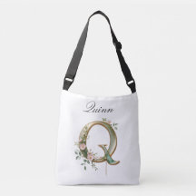 Bolsa transversal com letra Q floral em dourado el
