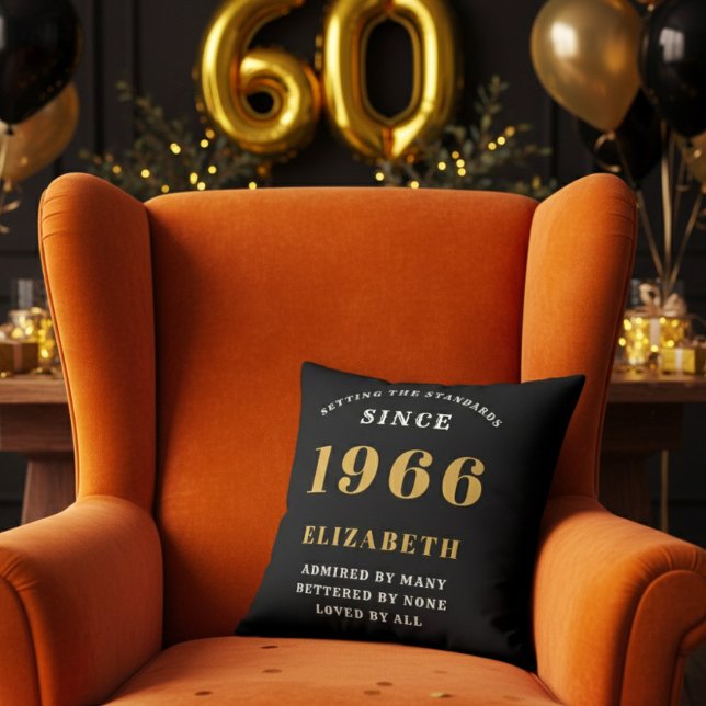 Almofada 60th Birthday Gift Personalized 1966 Black Gold (A personalized black pillow on a vibrant orange velvet wingback armchair )