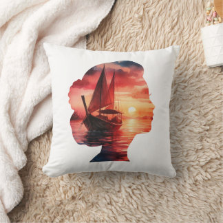 Almofada a woman's head enveloping a sunset with a sailboat