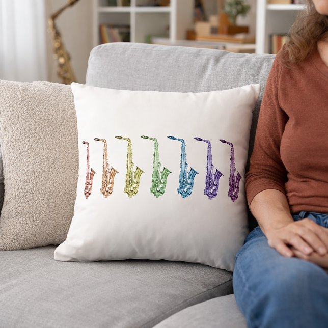 Almofada Música de Saxofones Arco-íris (A throw pillow with saxophones in red, orange, green, yellow, purple, blue & pink.)