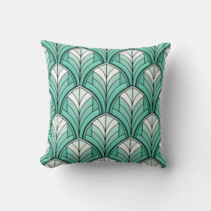 Almofada padrão art déco com tons de azul-turquesa, branco