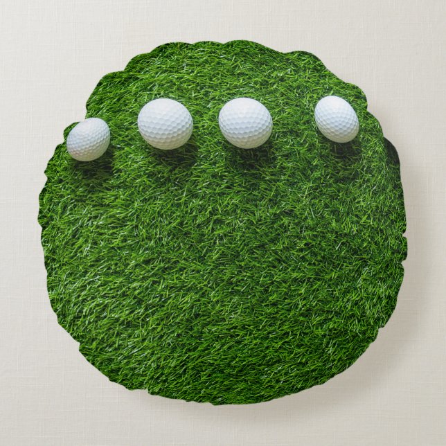 Almofada Redonda As bolas de golfe estão na grama verde (Frente)