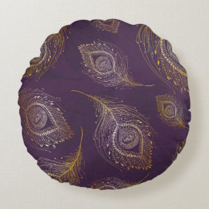 Almofada Redonda Dourada pena de pavão, fundo violeta.