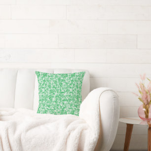 Almofada um fundo verde e branco com pequenos pontos branco