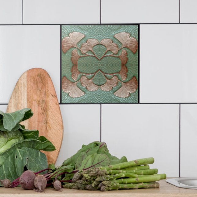 Azulejo de Gingko cerâmico (Single Green and copper Gingko leaf tile shown with white tiles in a kitchen.)