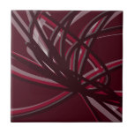 Bandas de Abstrato e borras<br><div class="desc">A azulejo da Borgonha e da cinza apresenta uma composição artística de fita de abstrato com tons de marrom e cinzas com sotaque branco sobre fundo colorido de vinho de burgundy.</div>
