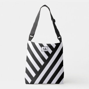 Bolsa de mão com monograma listrada em preto e bra