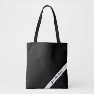 Bolsa de mão preta e branca com nome em faixa diag
