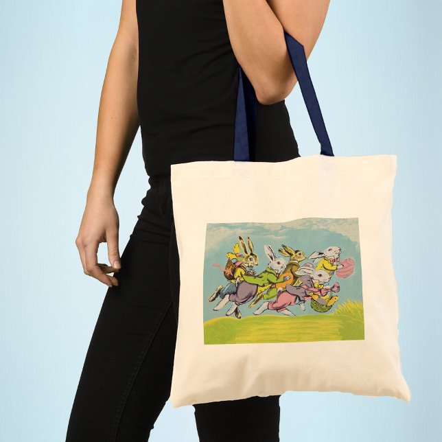 Bolsa Tote Coelhos de Pastel em páscoa (Group Easter bunnies running in grass baskets coloured eggs blue sky clouds on tote bag for Easter.)