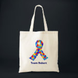Bolsa Tote Custom Autism Awareness Ribbon Blue Team Name<br><div class="desc">Custom Autism awareness ribbon tote bag for autistic friends or family. A cool proud autism mom or dad gift that can be personalized with any text below the puzzle piece ribbon of blue,  yellow,  and red. A neat Asperger Syndrome pride present.</div>