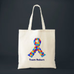 Bolsa Tote Custom Autism Awareness Ribbon Blue Team Name<br><div class="desc">Custom Autism awareness ribbon tote bag for autistic friends or family. A cool proud autism mom or dad gift that can be personalized with any text below the puzzle piece ribbon of blue,  yellow,  and red. A neat Asperger Syndrome pride present.</div>