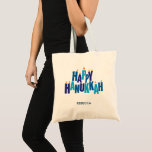 Bolsa Tote Feliz Feriado das Velas de Hanukkah<br><div class="desc">Faça o seu Chanukah comprar e recado um pouco mais festivo com esta bolsa de tote, ou use como presente ou favor. A saudação "Feliz Chanucá" é expressa em cores tonais azuis. As letras empilhadas servem como uma menorah com pequenas chamas queimando sobre nove "letras de vela". Adicione seu nome...</div>