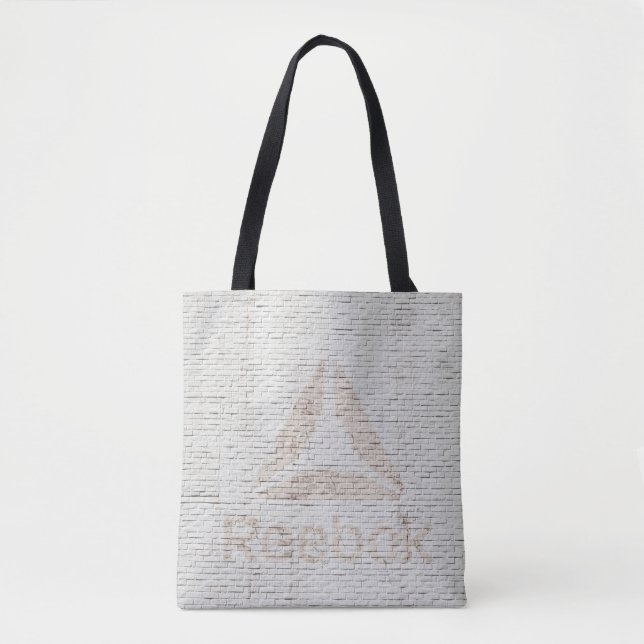 Bolsa Tote Foto de aproximação do logotipo Reebok na parede (Frente)