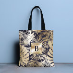 Bolsa Tote Marinho Dourado Tropical Monograma<br><div class="desc">Este moderno design chic mostra seu monograma sobre um fundo de um padrão floral tropical em ouro e marinho azul. #floral #tropical #marinho #navyblue #ouro #ouro #botânico #foliage #personalizado #monograma #monograma #inicial #elegante #na moda #moderna #feminina#bolsa #bolsas #totebags #acessórios #escritório #trabalho #escola #giftsforher #personalização presentes</div>