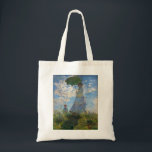 Bolsa Tote Monet The Promenade Woman com Parasol<br><div class="desc">Claude Monet A Promenade Mulher com Parasol. Pintura a óleo na canvas de 1875. Um dos mais charmosos trabalhos iniciais de Monet, The Promenade apresenta uma jovem mulher e uma criança em um campo acima das flores silvestres amarelas. A mulher segura um parasol verde e azul enquanto o vento puxa...</div>