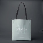 Bolsa Tote Monograma e nome da Bridesmaid Personalizada<br><div class="desc">Adicione um toque pessoal ao seu casamento com o monograma personalizado da dama de honra e o presente de nome. Este design apresenta o nome da dama de honra personalizada com título e data de casamento em branco e monograma em verde-sábio como fundo, no estilo clássico de fonte serif, em...</div>