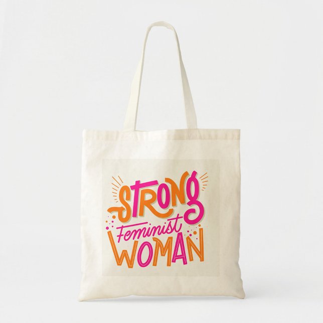 Bolsa Tote Mulheres Fortes (The text reads "STRONG FEMINIST WOMAN" in a playful, hand-drawn style. )