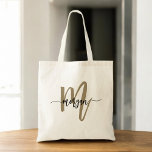 Bolsa Tote Nome do Monograma de Script Moderno Dourado Preto<br><div class="desc">Carregar o seu estilo essencial com a Tote Bag de Nome do Monograma do Script Moderno Preto e Dourado. Apresentando uma canvas preta elegante com um monograma dourado ousado em uma fonte moderna, esta bolsa de tote combina elegância e funcionalidade. Espacial o suficiente para comprar, trabalhar ou usar diariamente, ele...</div>