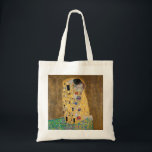 Bolsa Tote O Beijo de Gustav Klimt<br><div class="desc">O Beijo de Gustav Klimt O Beijo é uma pintura de óleo na canvas com folhas de ouro, prata e platina adicionadas pelo pintor simbolista austríaco Gustav Klimt. Ela foi pintada em algum ponto em 1907 e 1908, no auge do que os estudiosos chamam de "Período Ouro". Apresentando tonalidades de...</div>