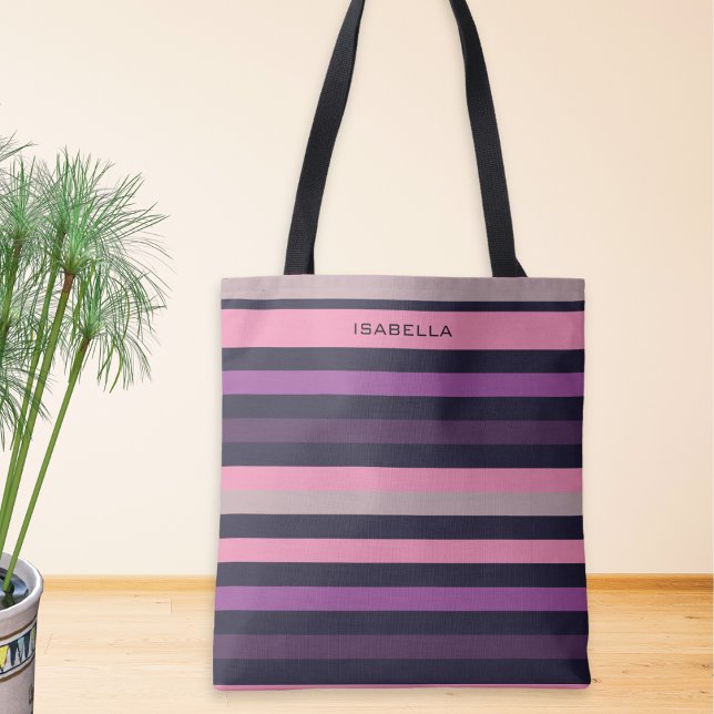 Bolsa Tote Personalizado Moderno com Listras Rosa Roxo (A stylish tote bag with pink, lilac and purple striped print, personalized with a name at the top)
